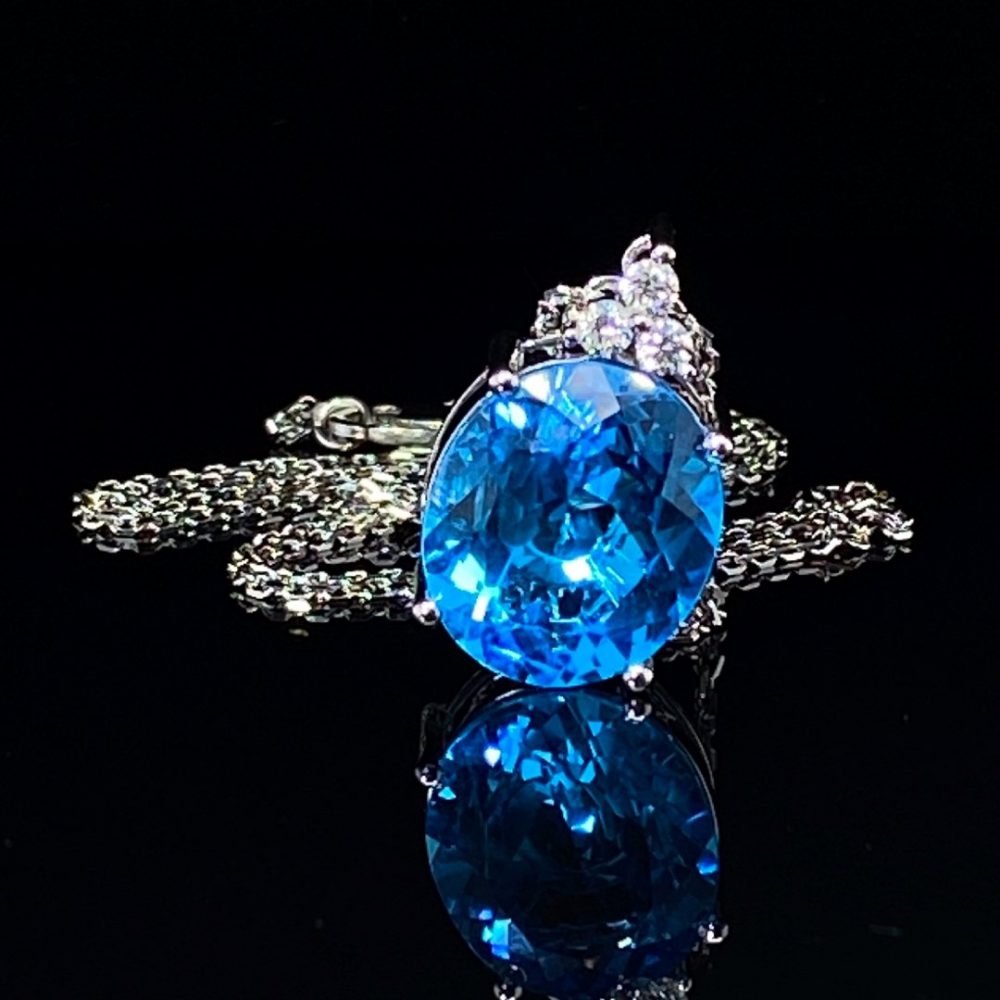 Stunning Swiss Blue Topaz and Diamond oval pendant front view on black