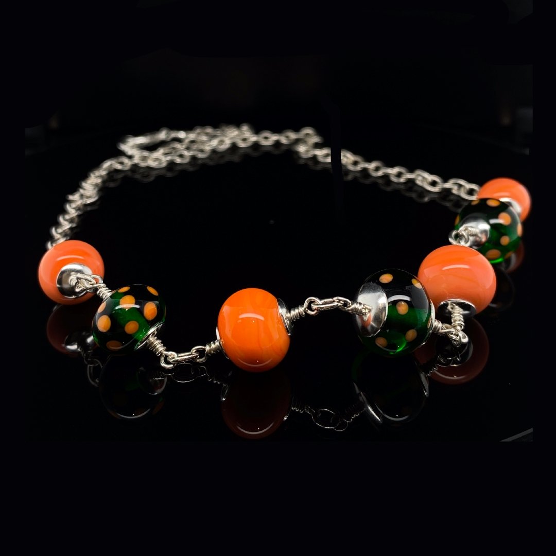 Orange and green murano glass necklace by Heidi Kjeldsen Jewellery NL1273 on black